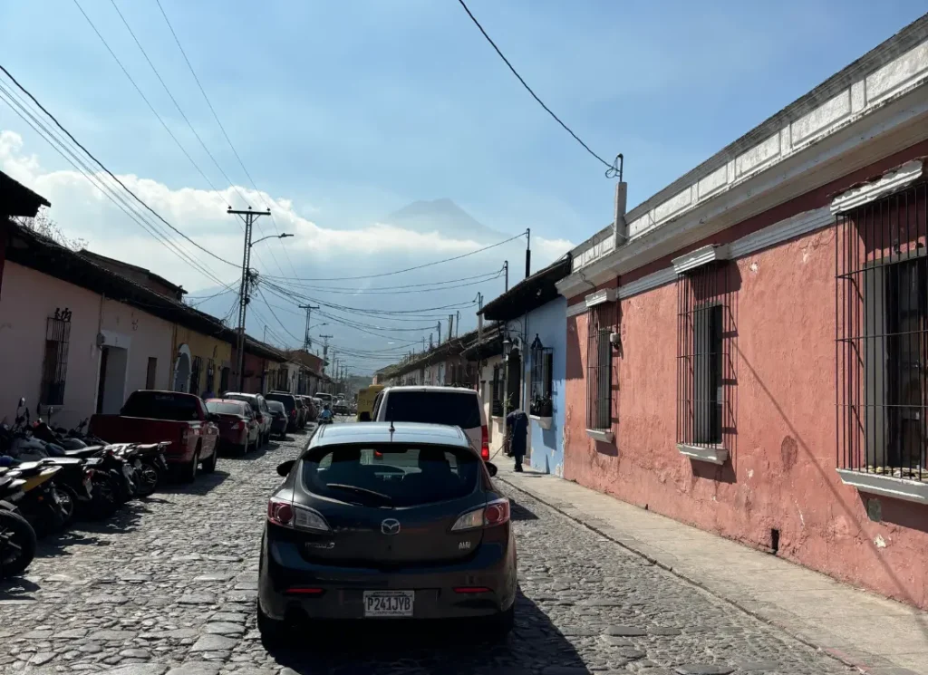 A view of a street and a volcano in Antigua, Guatemala