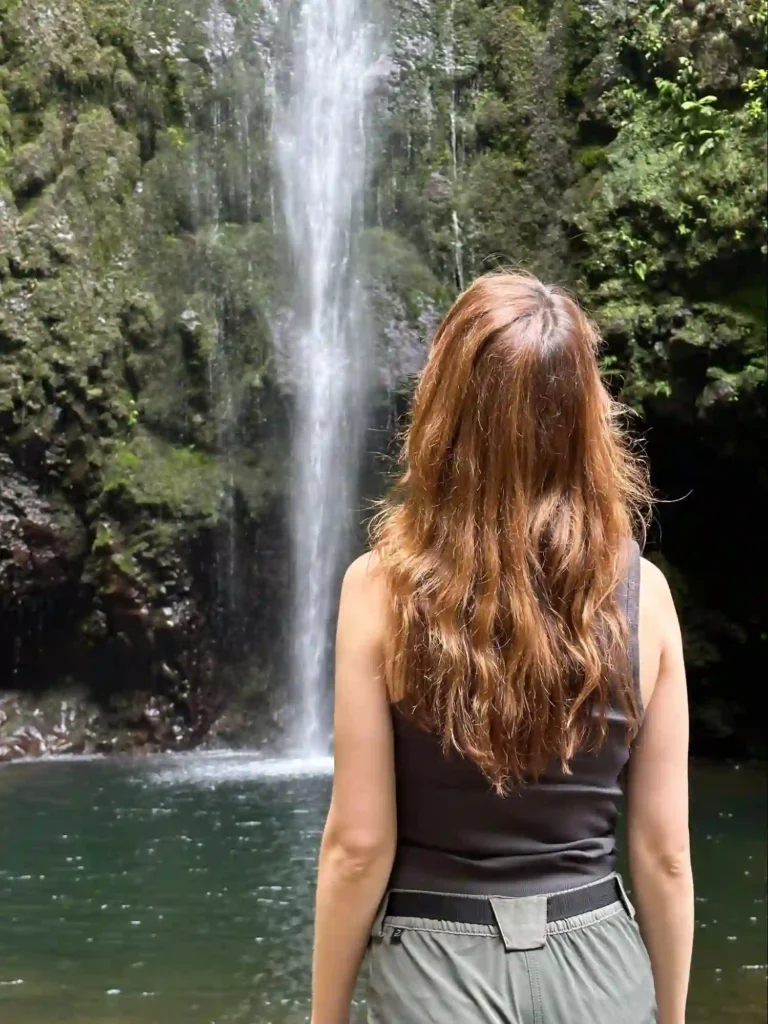 Laura looking up at a waterfall in Madeira
