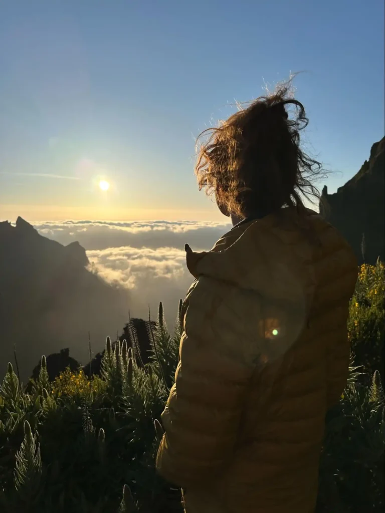 Laura looking over a Madeira cloud inversion with a yellow jacket