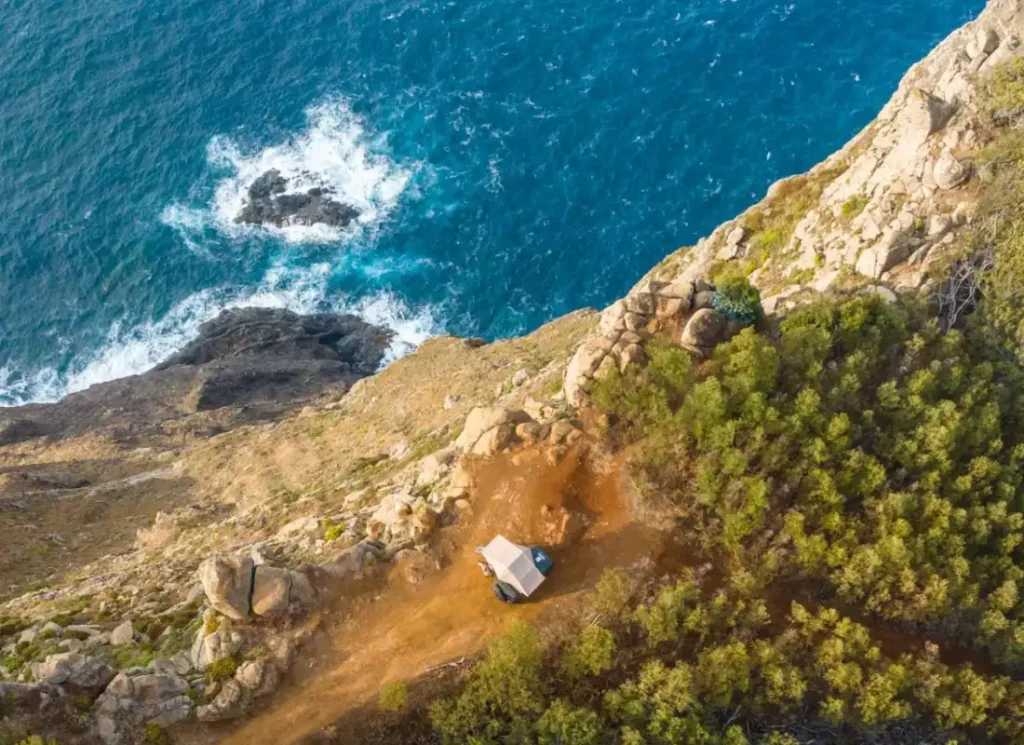 A drone shot of a campervan on the coast of Madeira