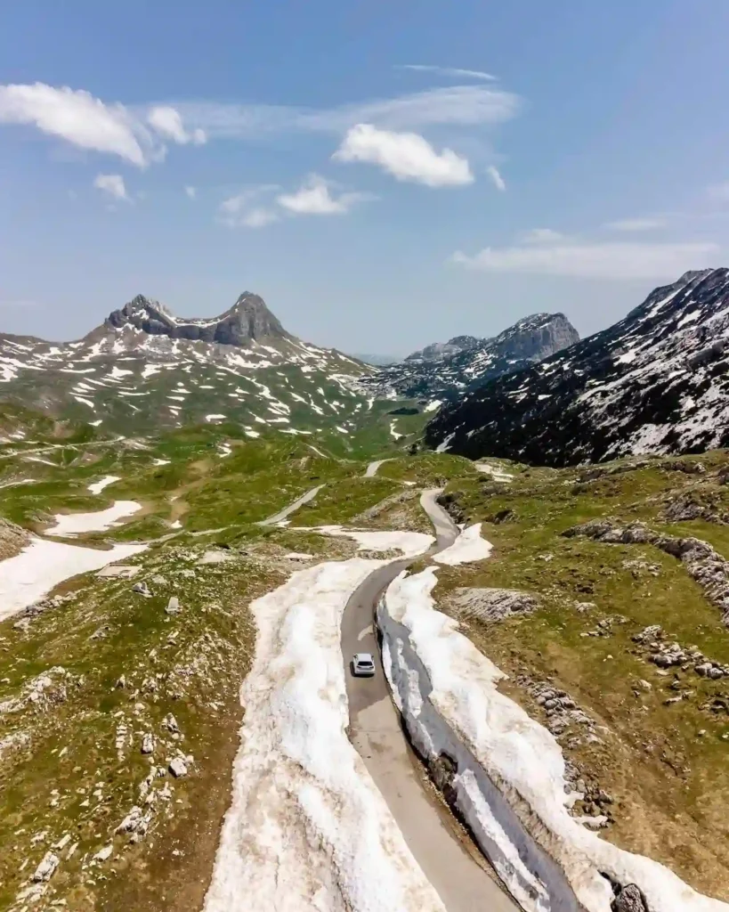 Laura and her partner driving through Durmitor National Park