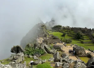 The ruins of Machu Picchu emerging from the mist during rainy season