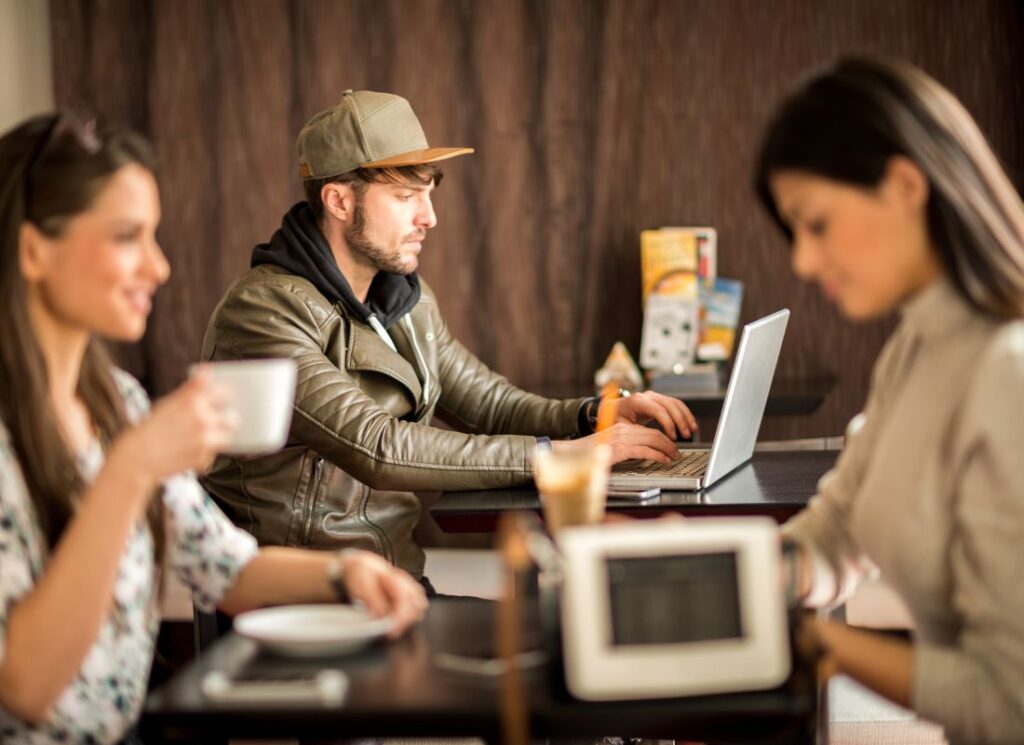 three digital nomads working in a coworking space