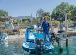 A man on a boat at the docks of Panajachel