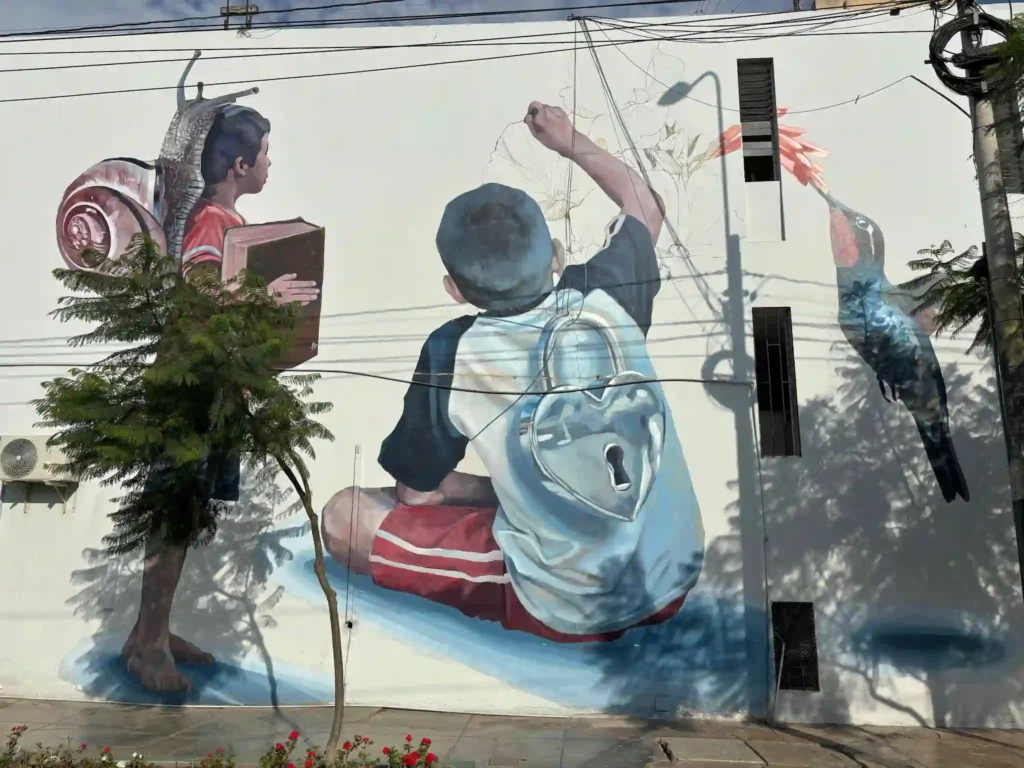 Some street art on a white wall in Barranco, Lima